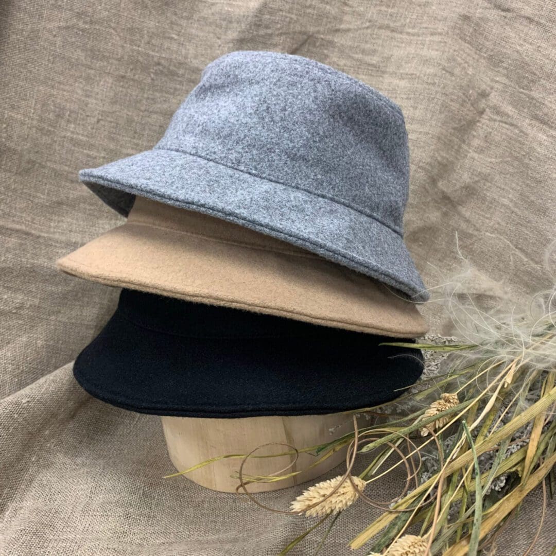 A stack of four hats on top of each other.