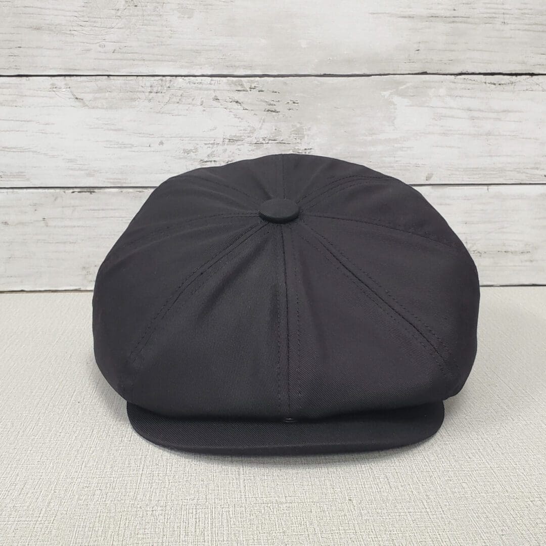 A black hat is sitting on the ground