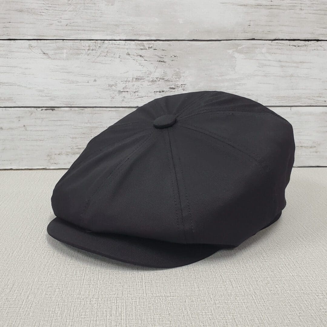 A black hat is sitting on the floor