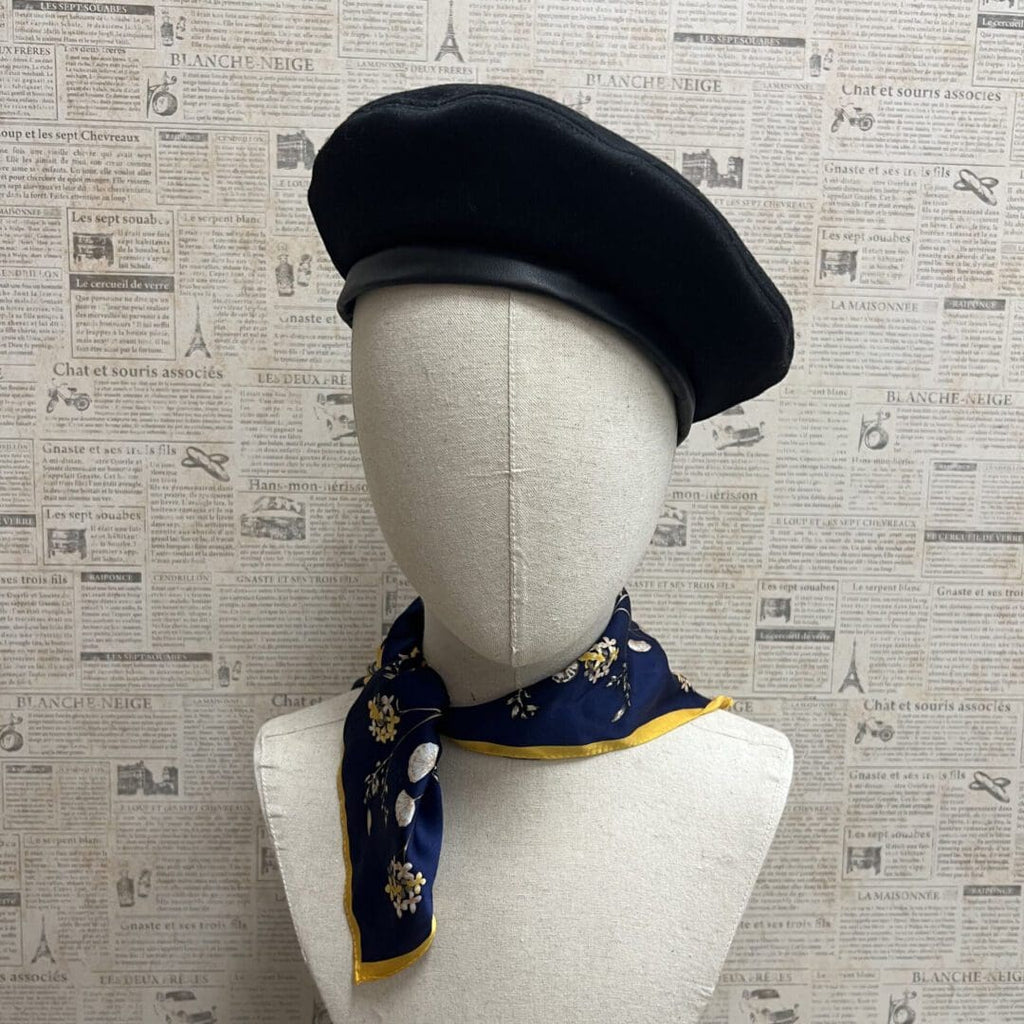 A mannequin wearing a hat and scarf.