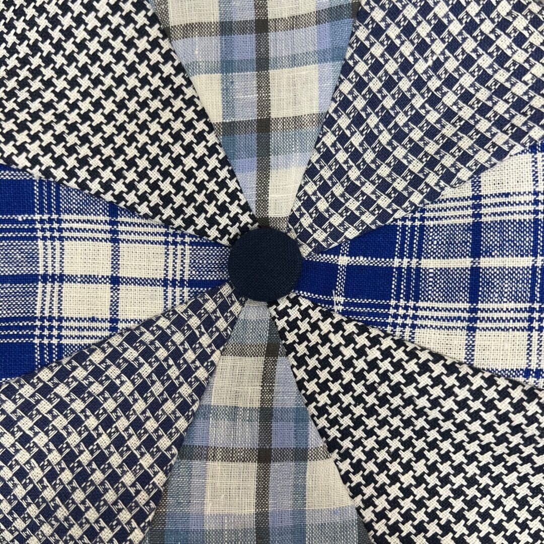 A close up of the fabric for a plaid umbrella