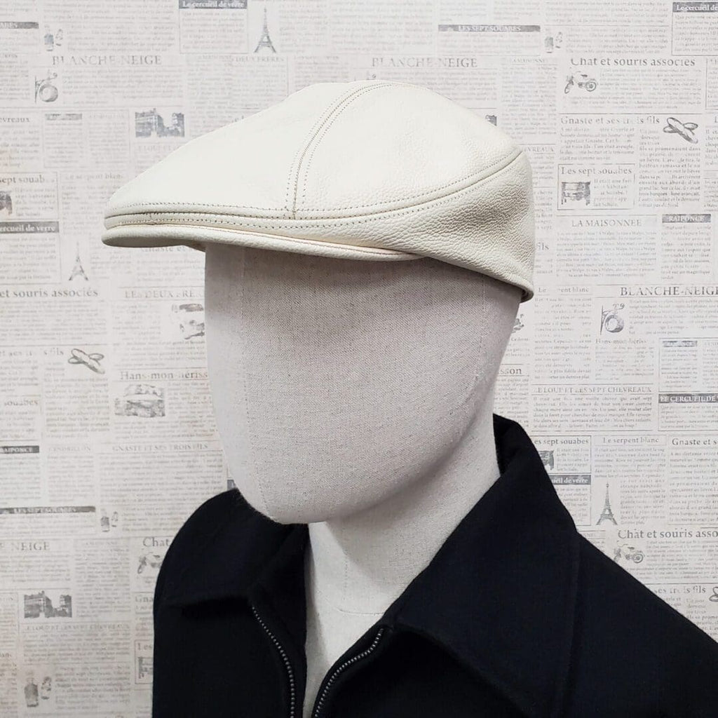 A man wearing a white hat and black jacket.