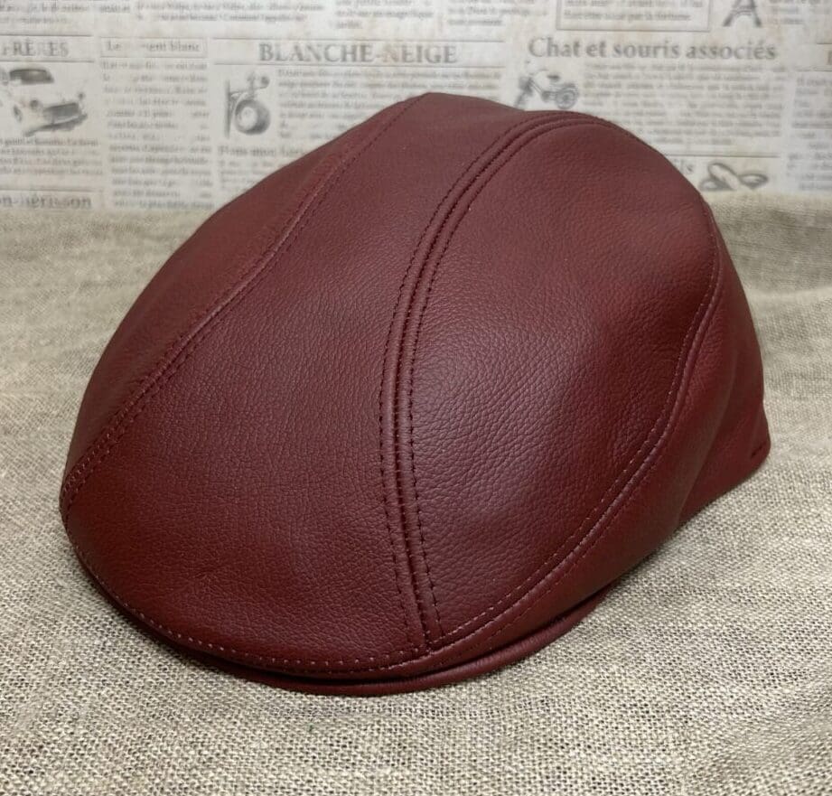 A brown leather cap is sitting on the floor.