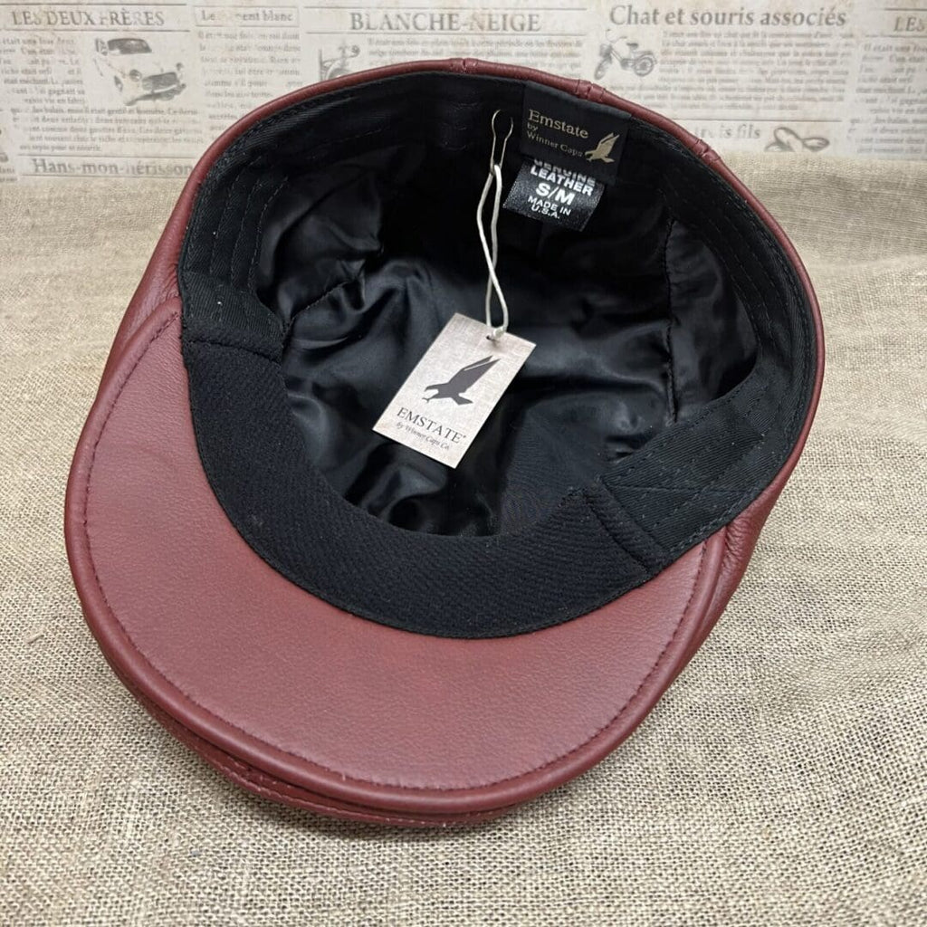 A red hat with a black cap on top of it.