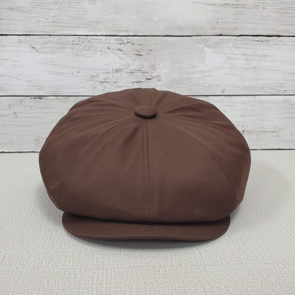 A brown hat sitting on top of a wooden table.