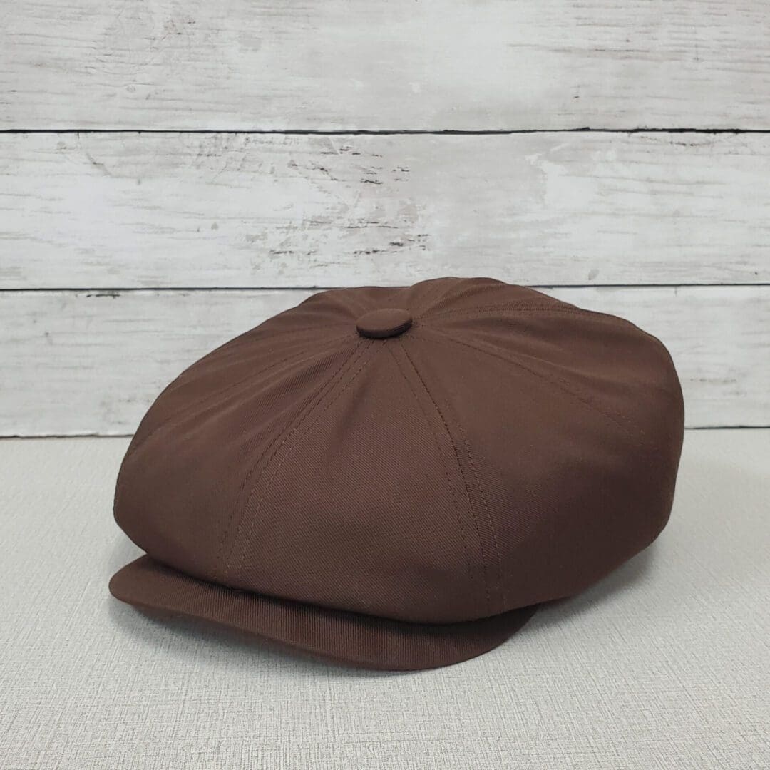 A brown hat sitting on top of a table.