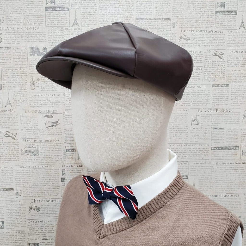 A mannequin wearing a brown hat and bow tie.