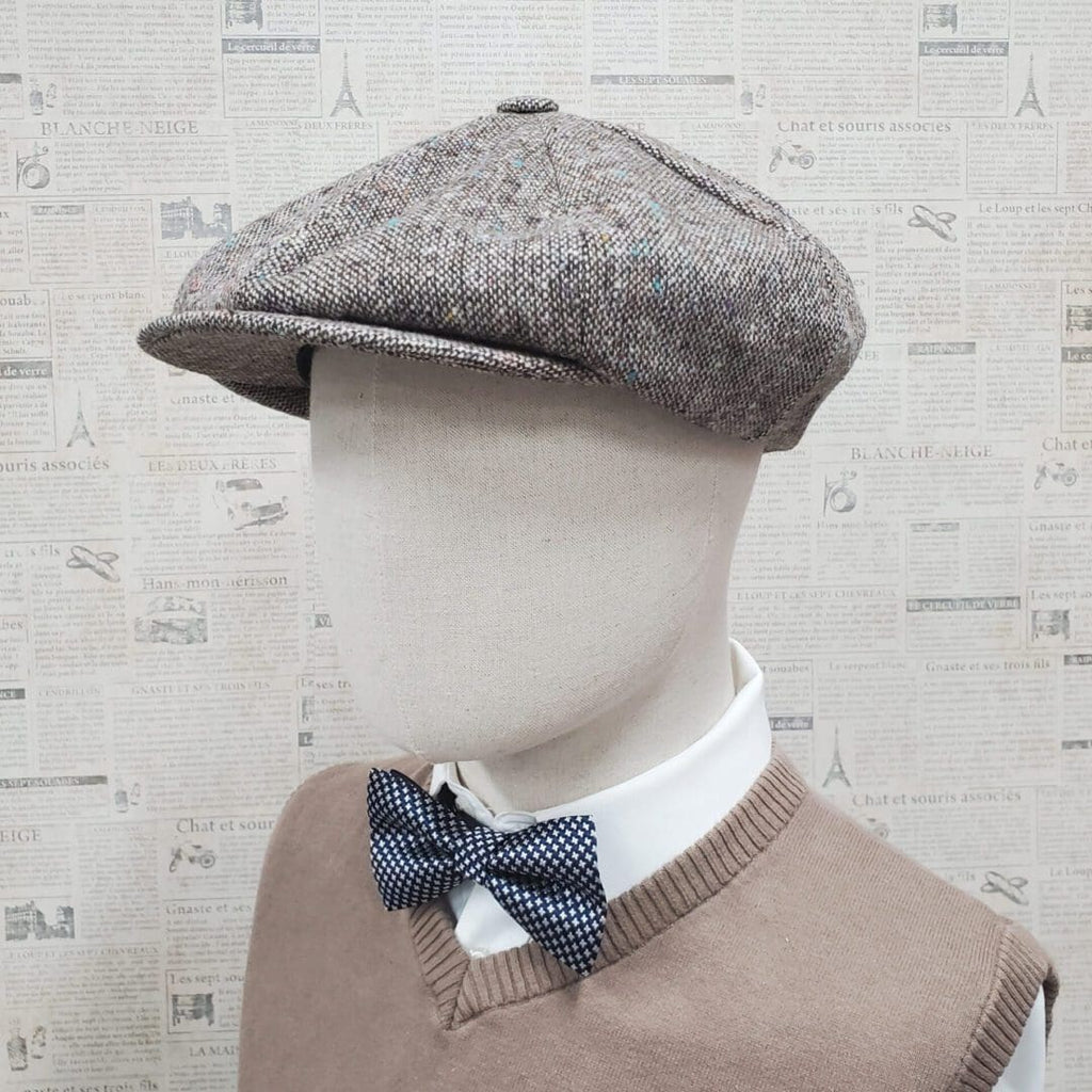 A man wearing a bow tie and a hat.