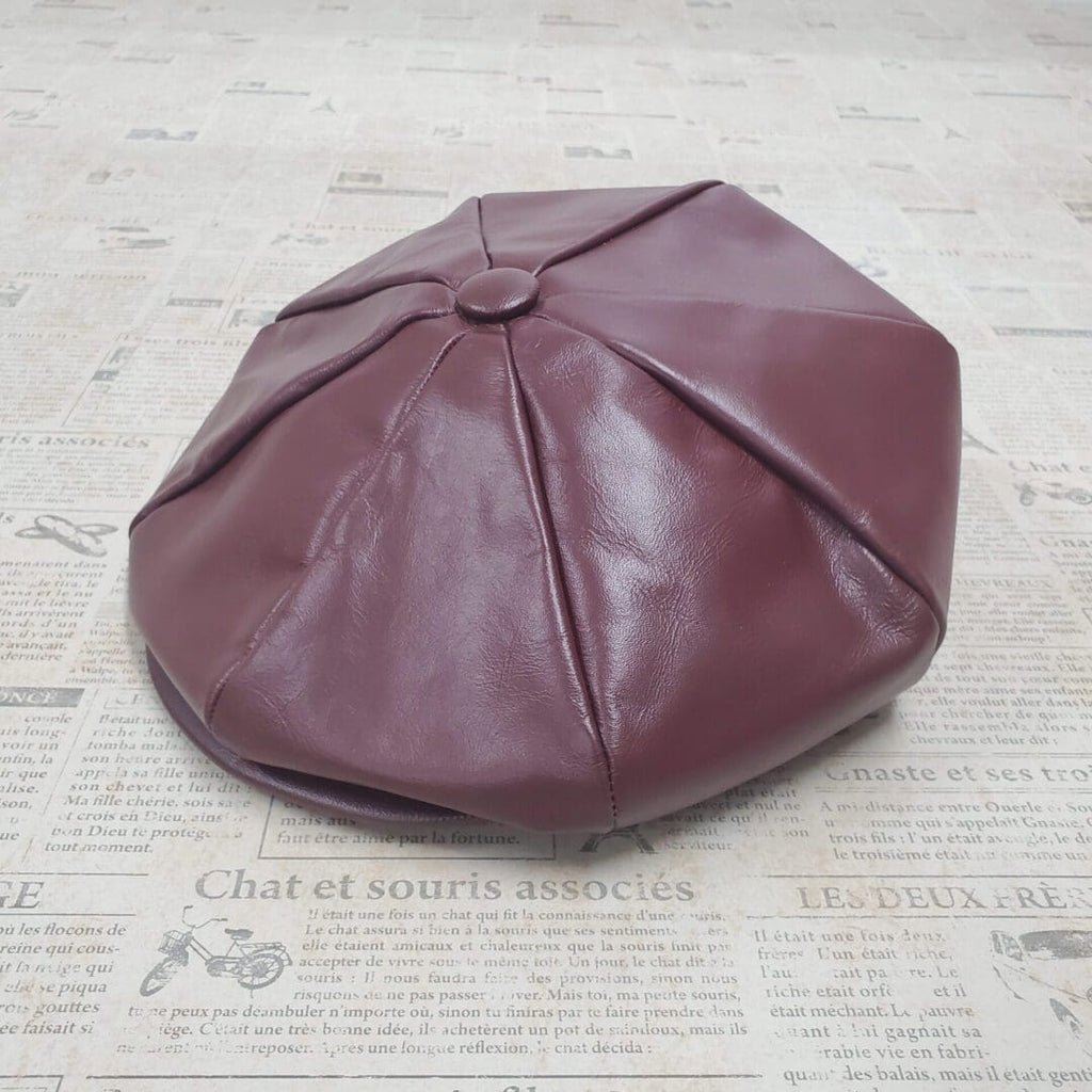 A brown leather hat sitting on top of a floor.