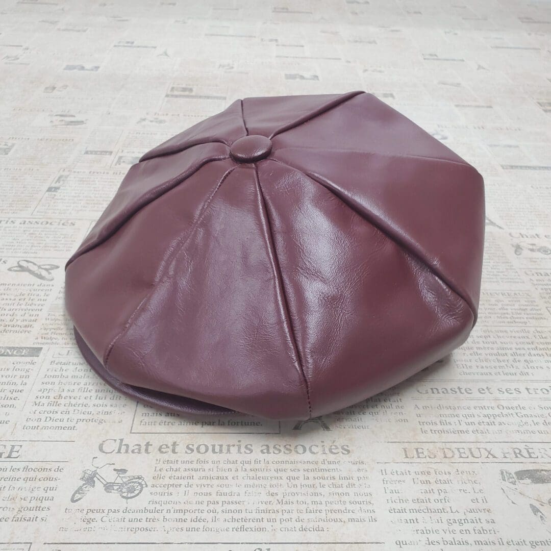 A brown leather hat sitting on top of a floor.