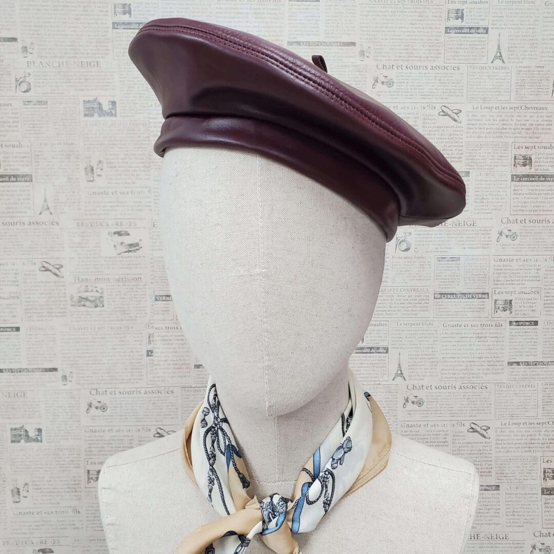 A mannequin wearing a hat and scarf.