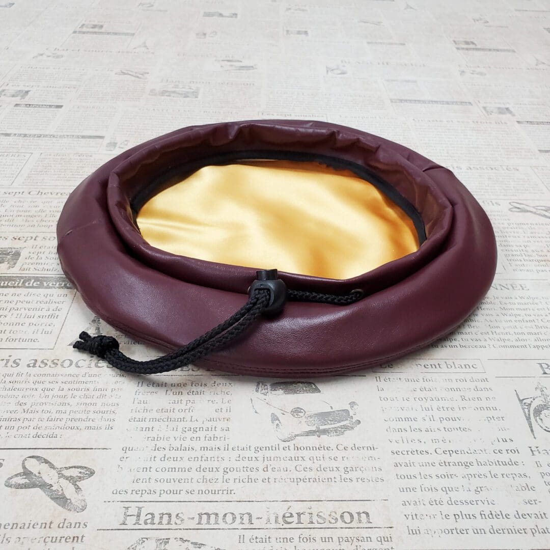 A brown leather purse sitting on top of a table.