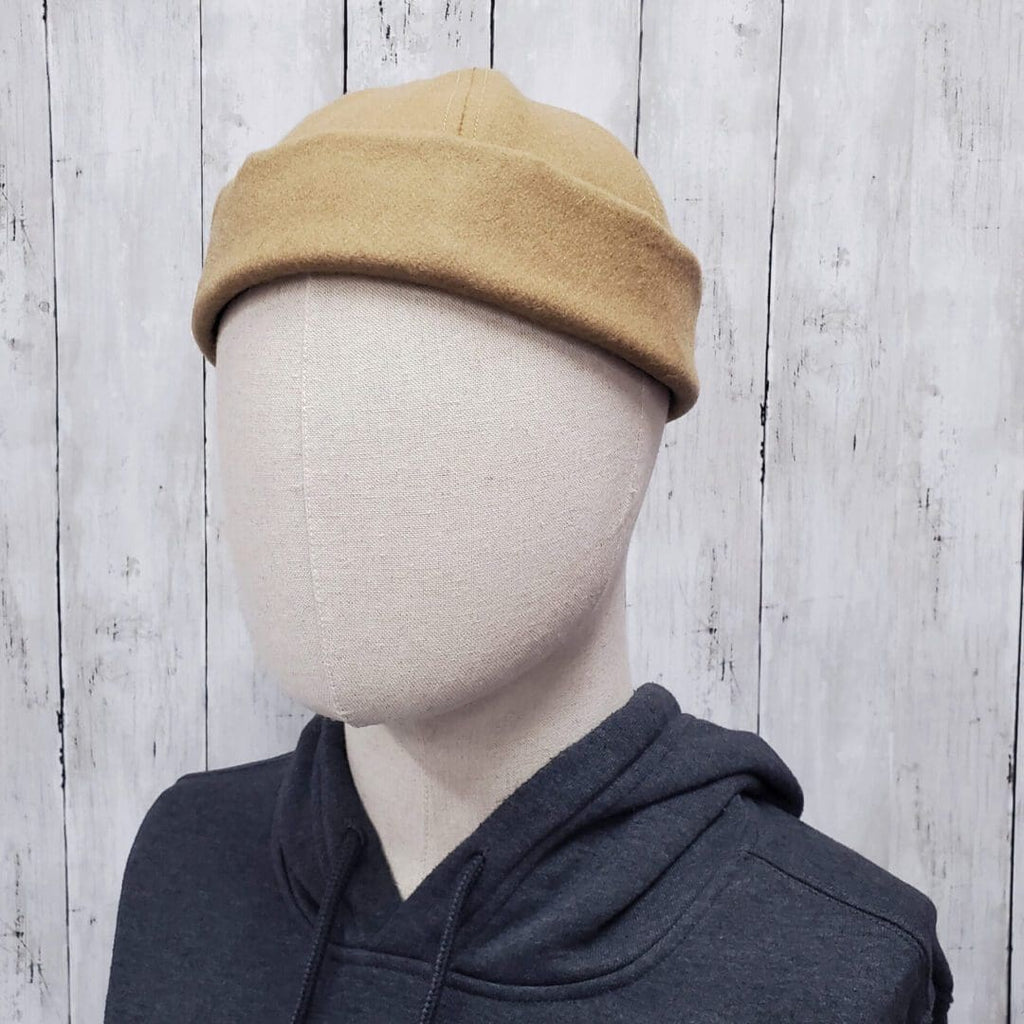 A person wearing a hat and a black hoodie