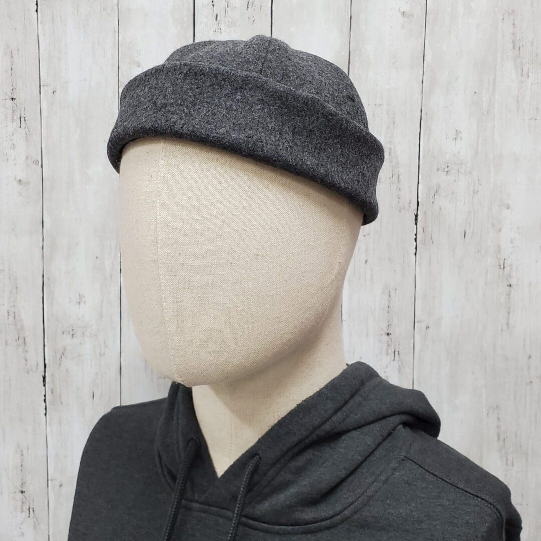 A mannequin wearing a hat and hoodie.
