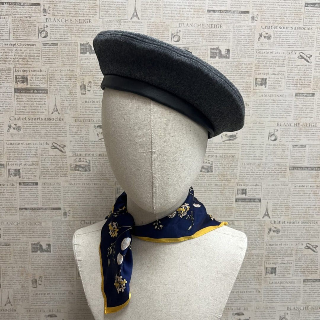A mannequin wearing a hat and scarf.