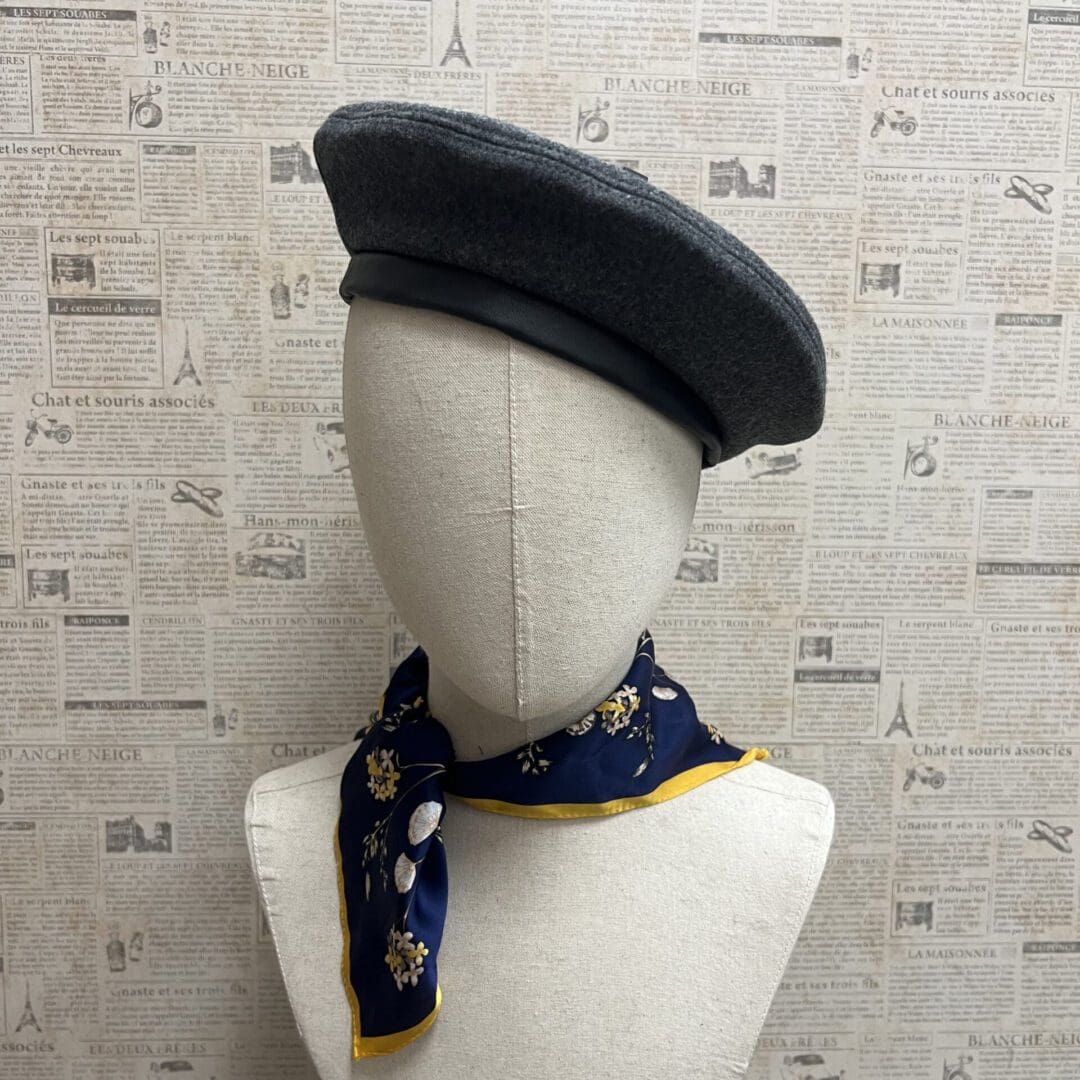 A mannequin wearing a hat and scarf.