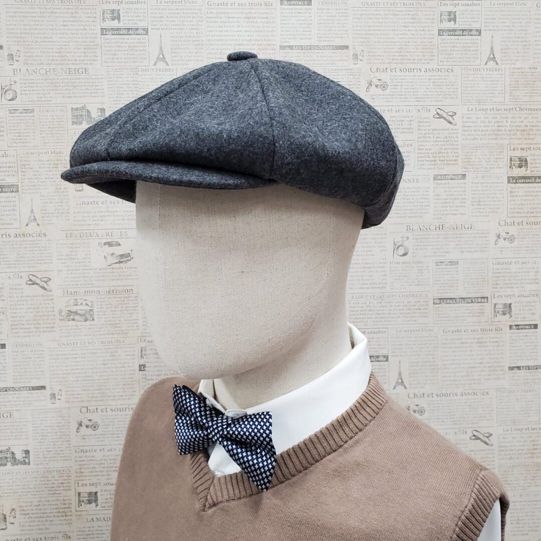 A mannequin wearing a bow tie and a hat.