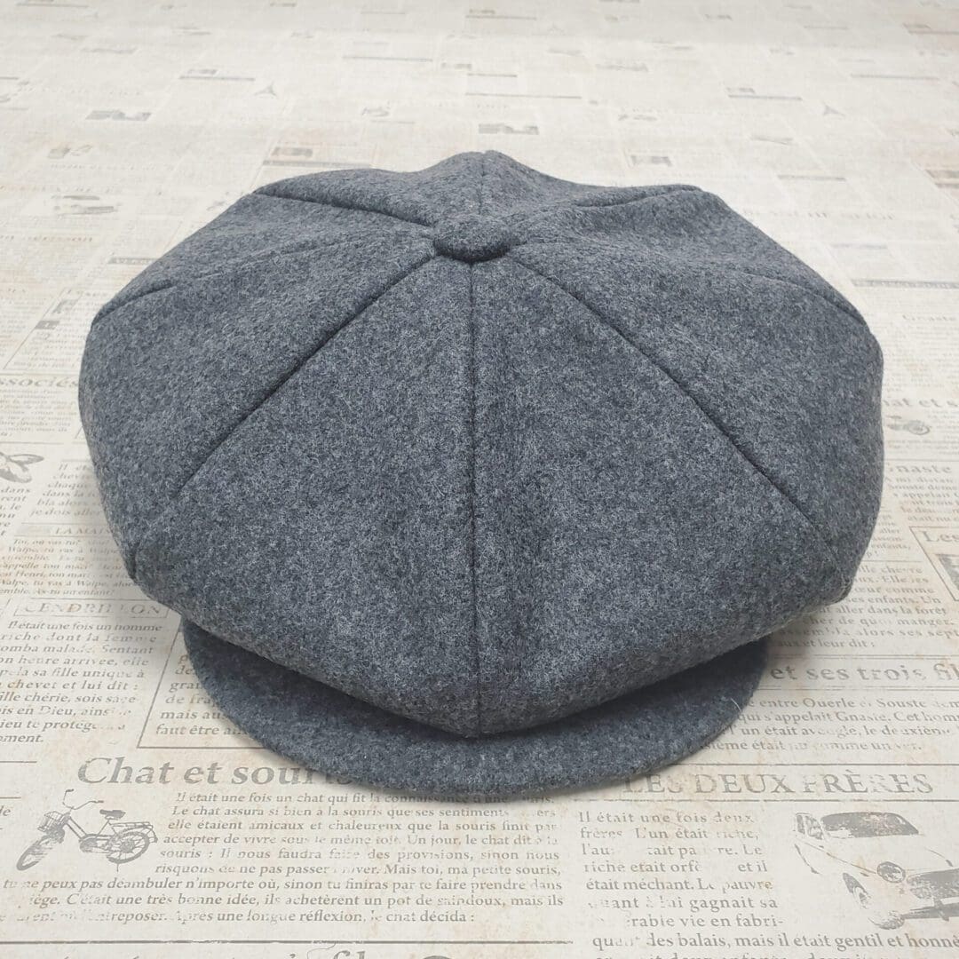 A gray hat is laying on the floor
