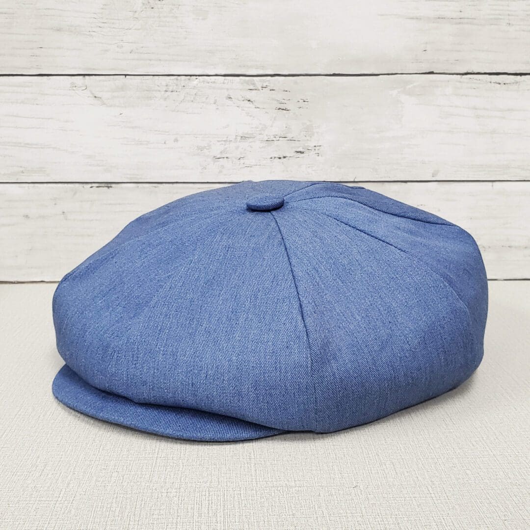 A blue hat is sitting on top of a table.