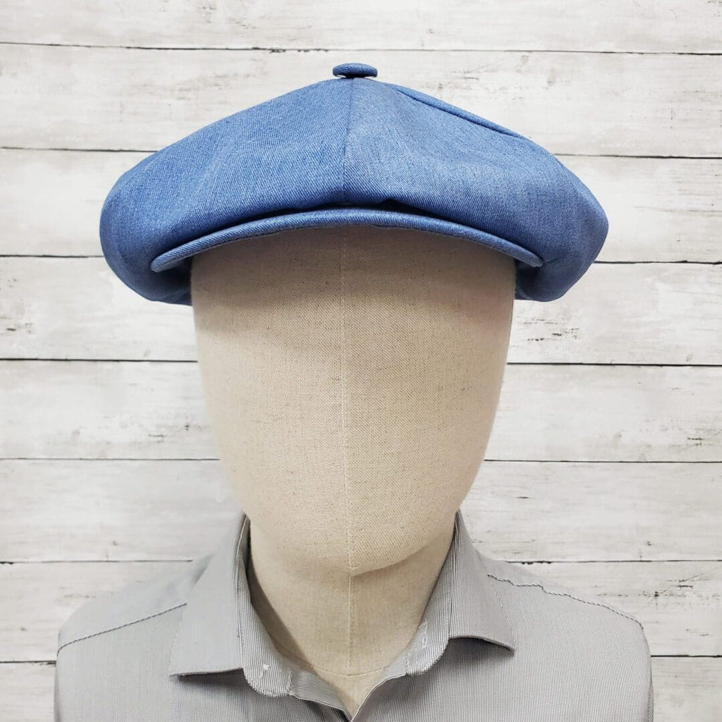 A mannequin wearing a blue hat and shirt.