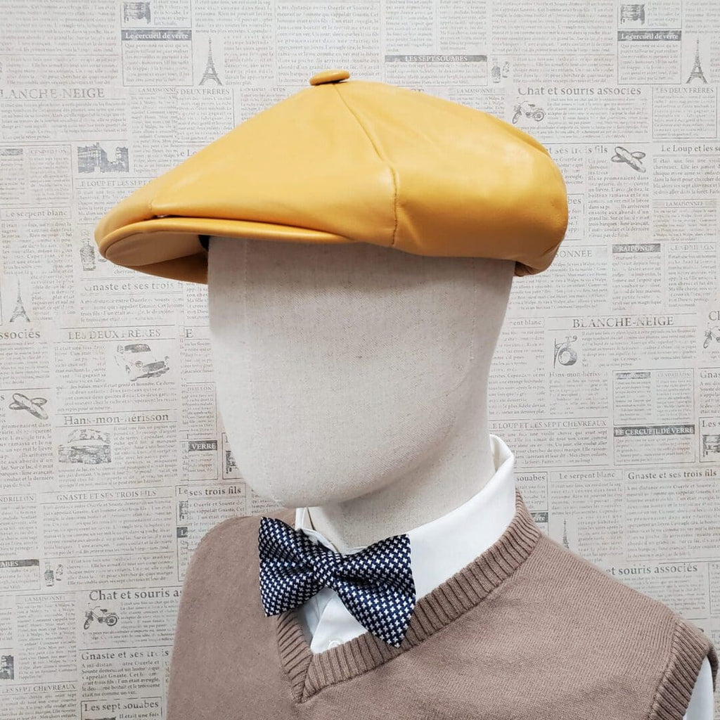A man wearing a yellow hat and bow tie.