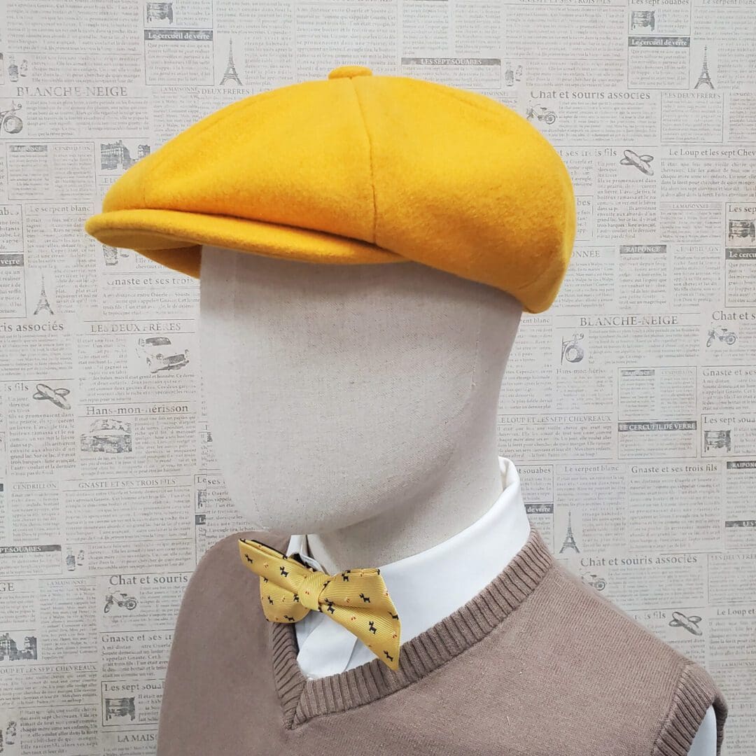 A mannequin wearing a yellow hat and bow tie.