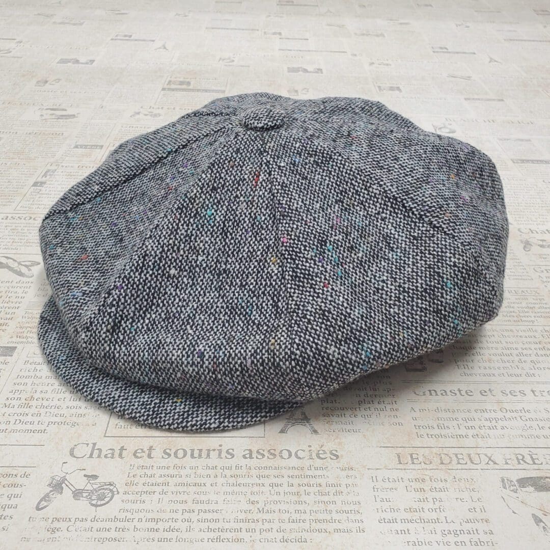 A gray hat is sitting on the floor.