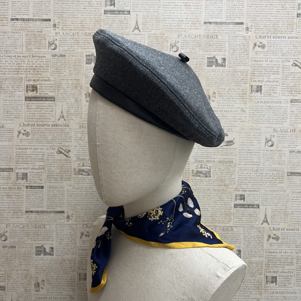 A mannequin wearing a hat and scarf.