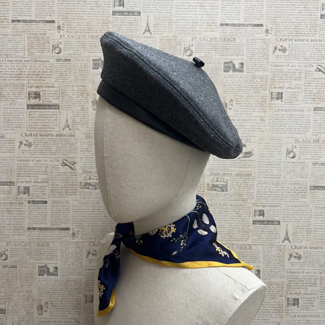 A mannequin wearing a hat and scarf.