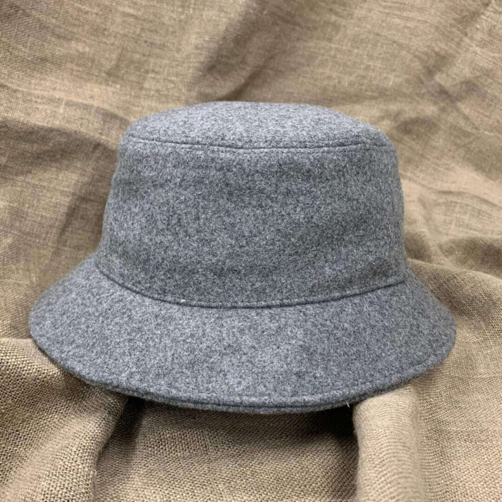 A gray hat is on top of the brown cloth.