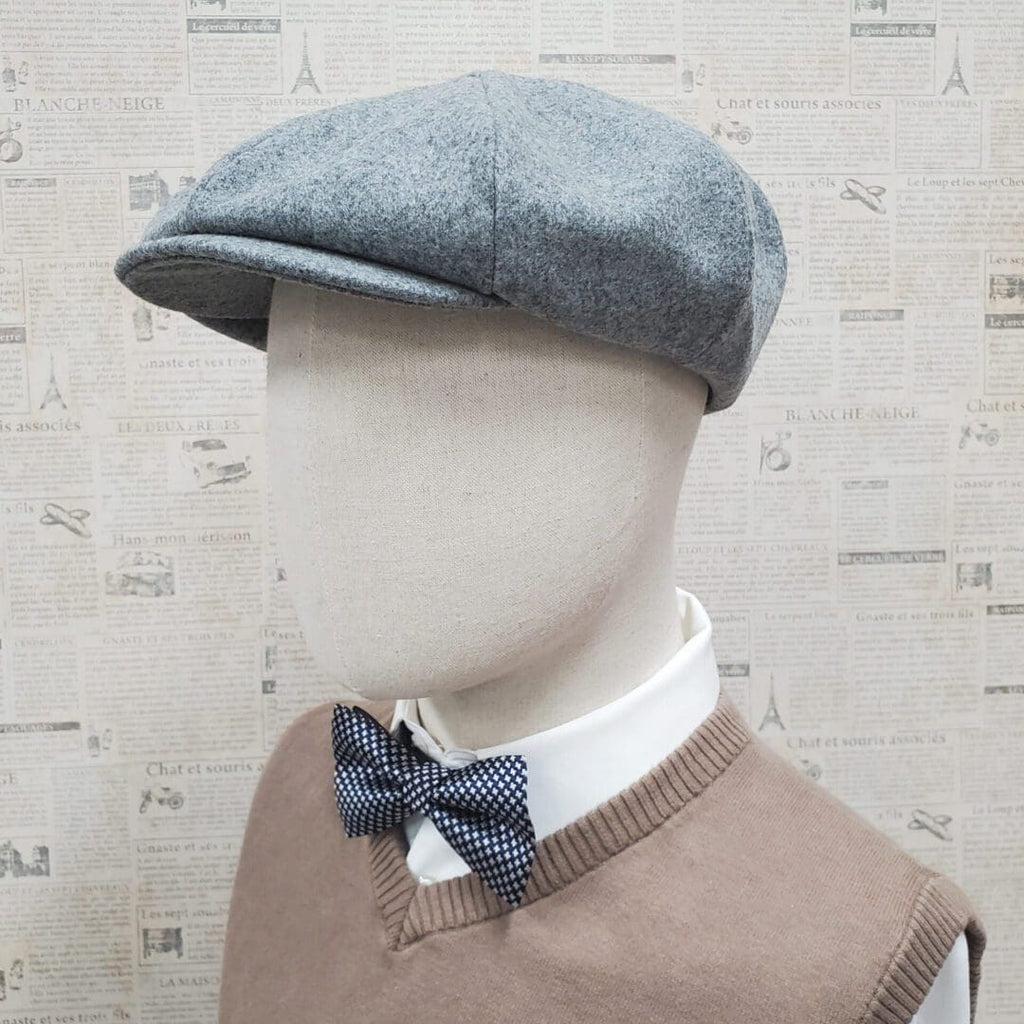 A mannequin wearing a bow tie and a hat.