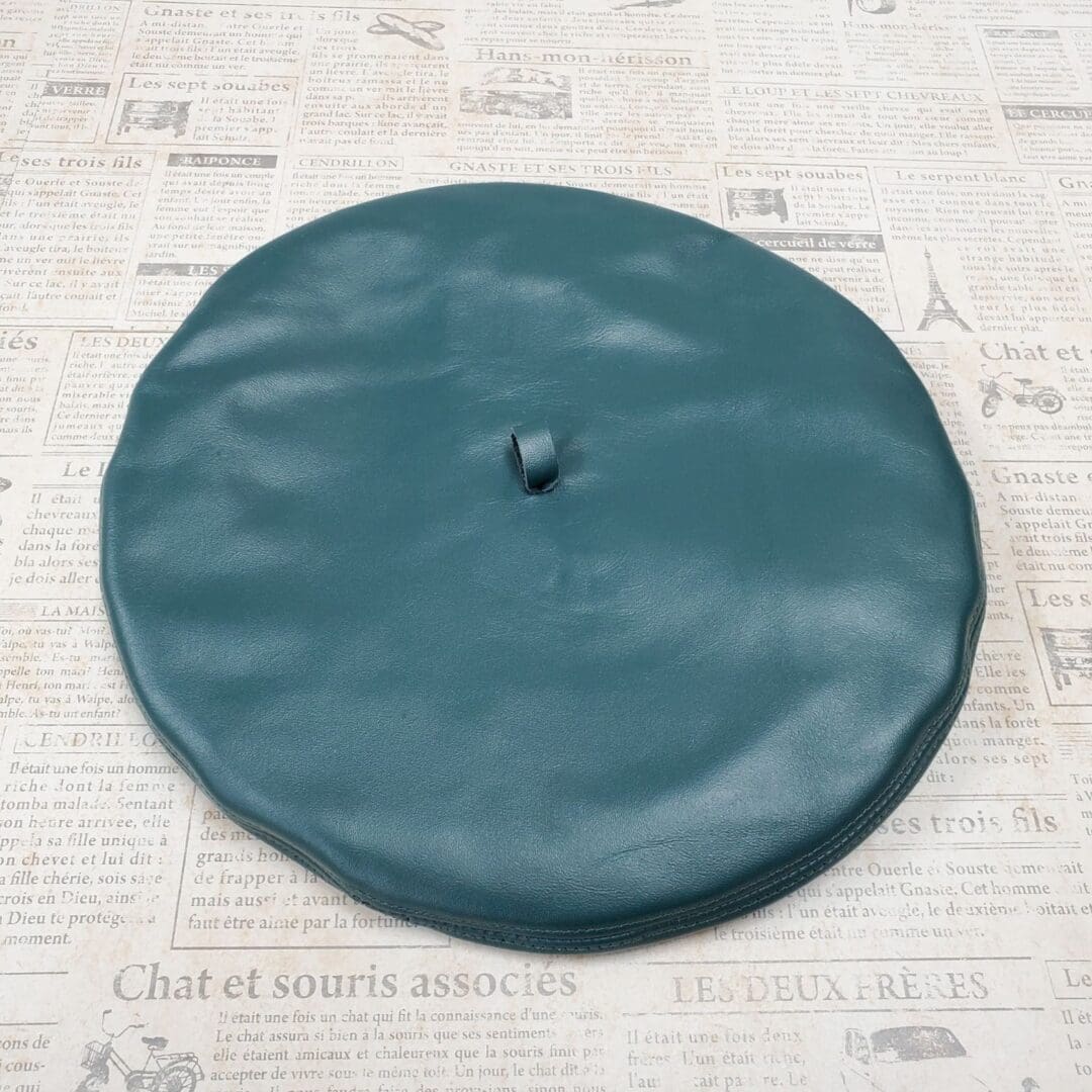 A green hat sitting on top of a table.