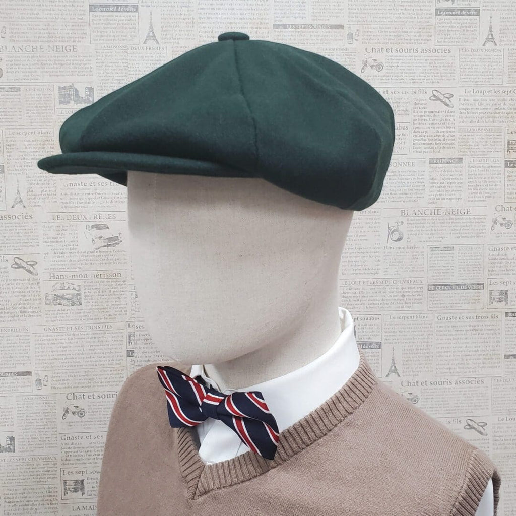 A mannequin wearing a green hat and bow tie.