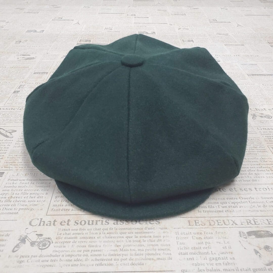 A green hat is sitting on the floor.
