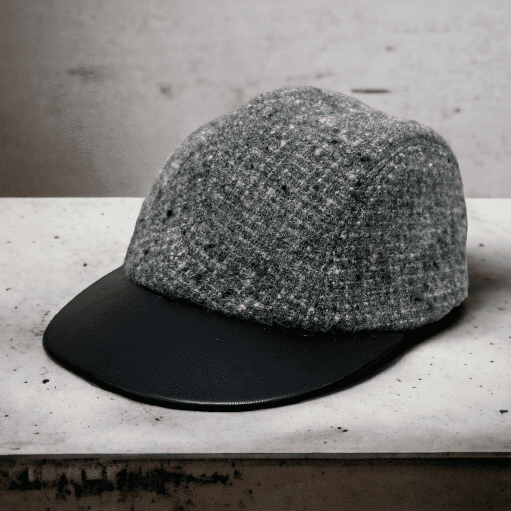 A hat is sitting on the ledge of a bench.