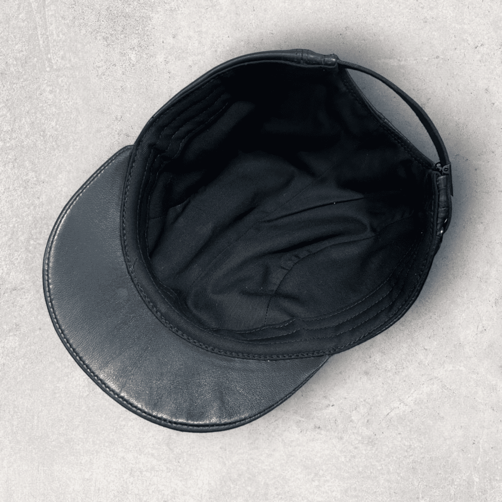 A black hat is laying on the ground