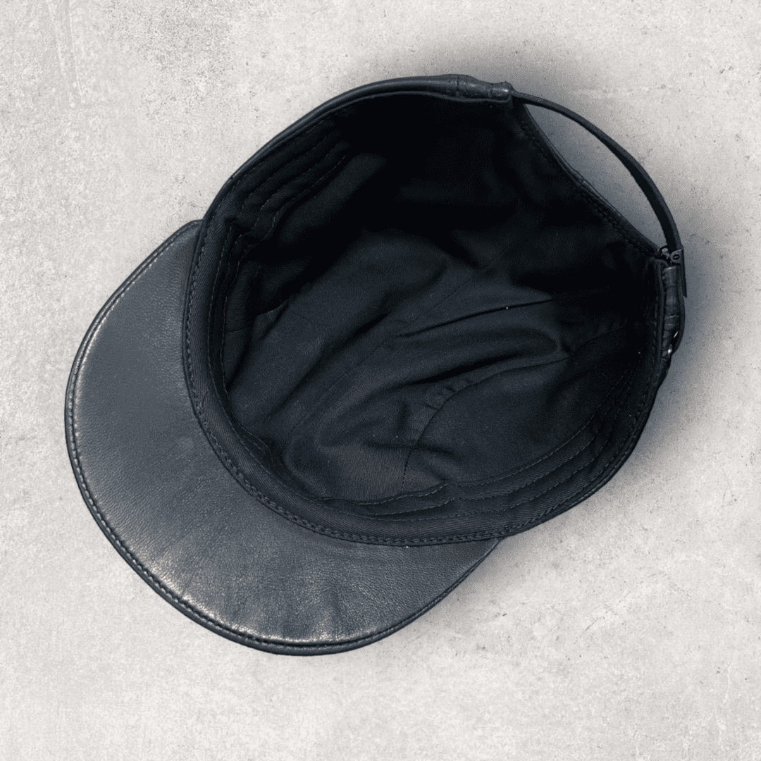 A black hat is laying on the ground