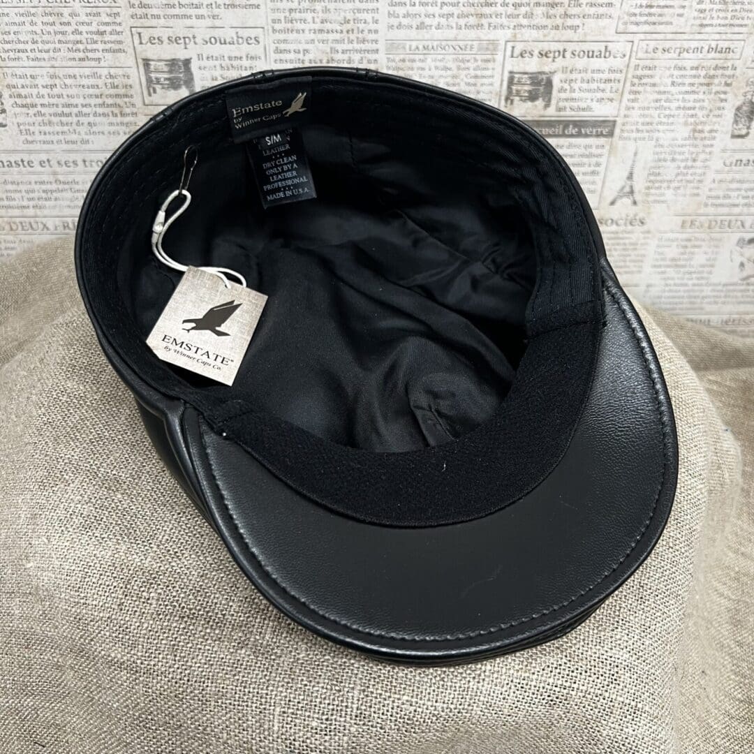 A black hat with a tag hanging from it's side.