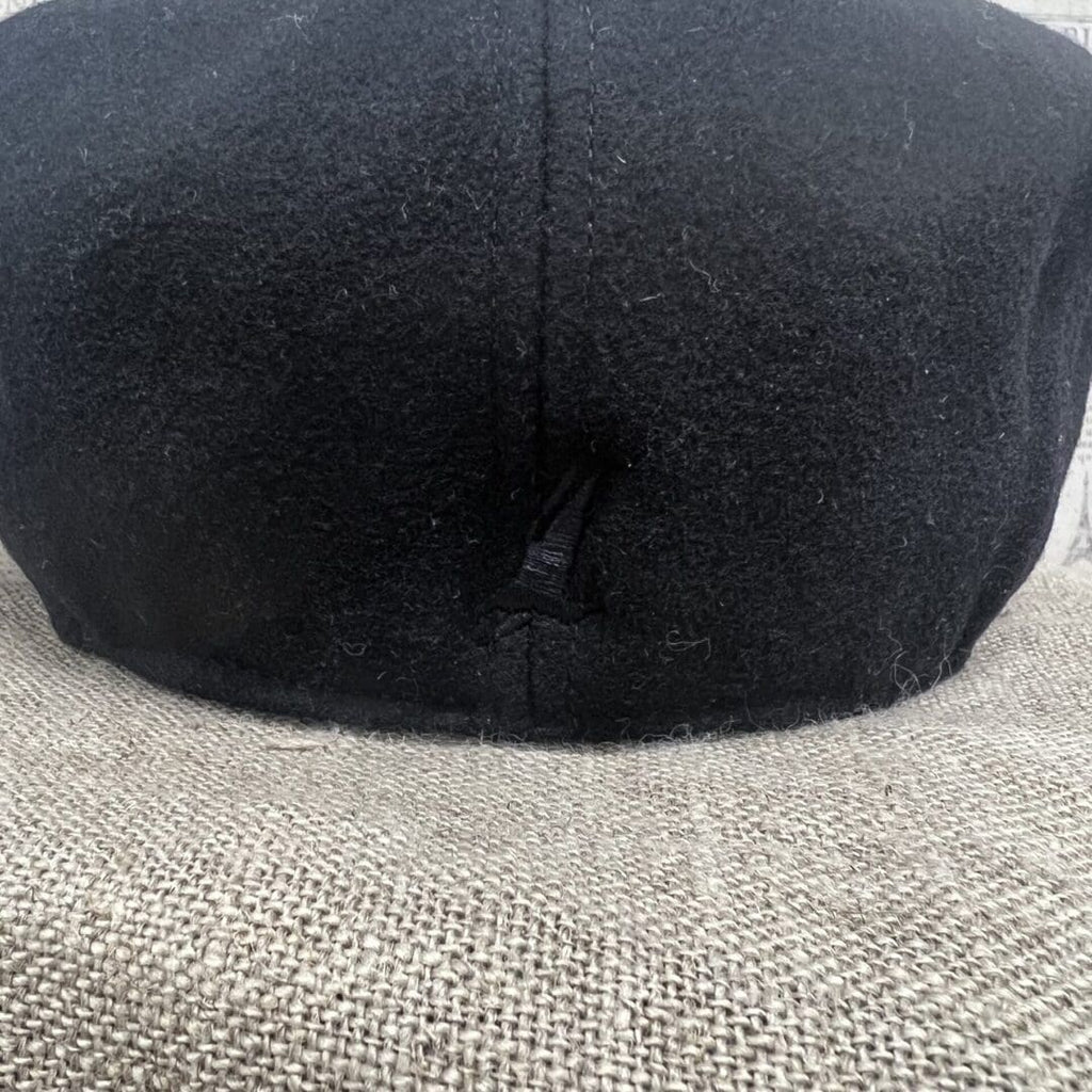 A black hat is on top of the head