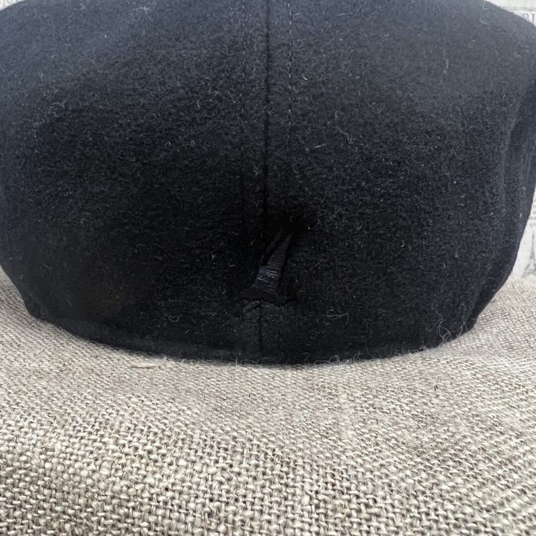 A black hat is on top of the head