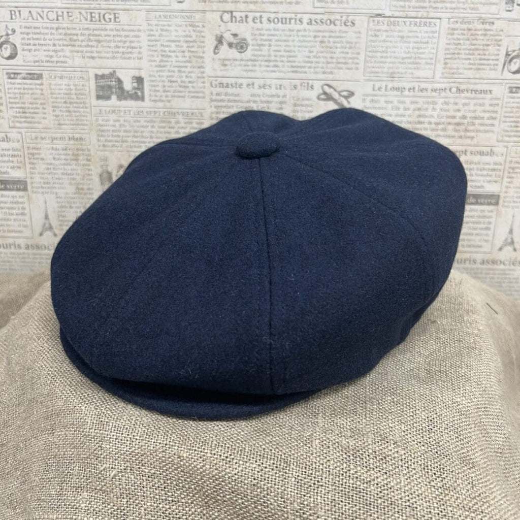 A hat is shown on top of a blanket.