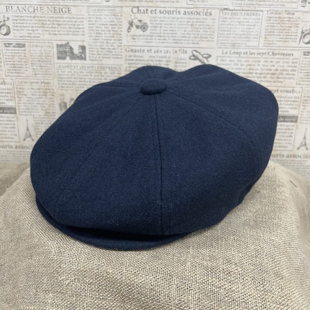 A hat is shown on top of a blanket.