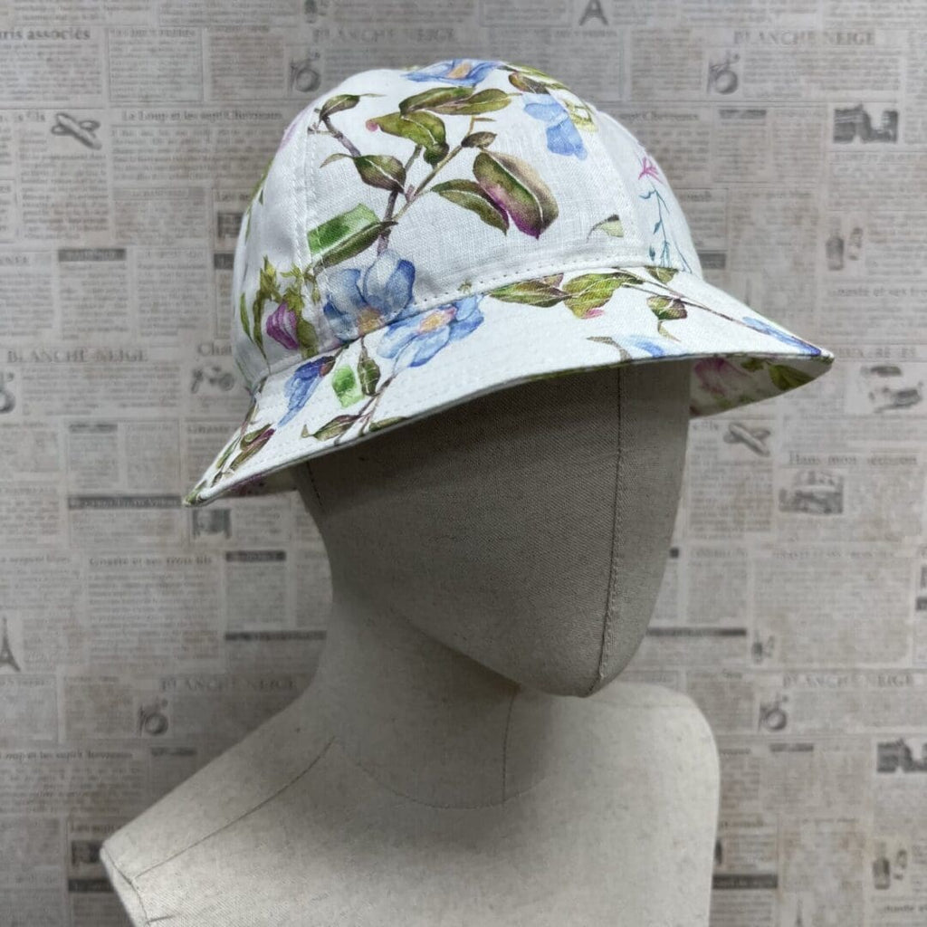 A mannequin wearing a hat with flowers on it.