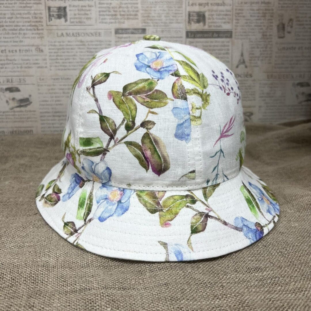 A white hat with blue flowers on it.