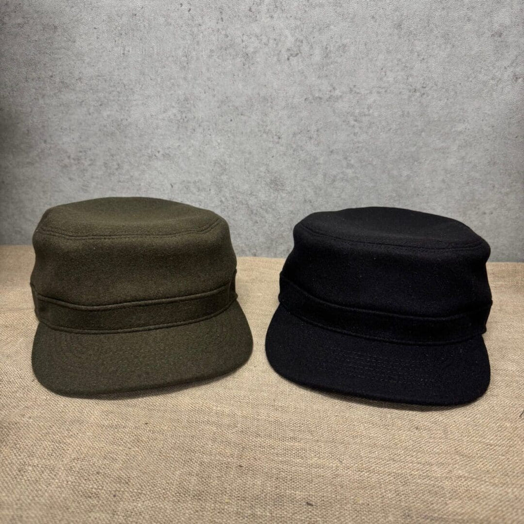 Two military-style hats on a table.