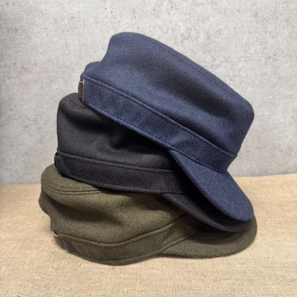 Stacked blue, black, and green caps.