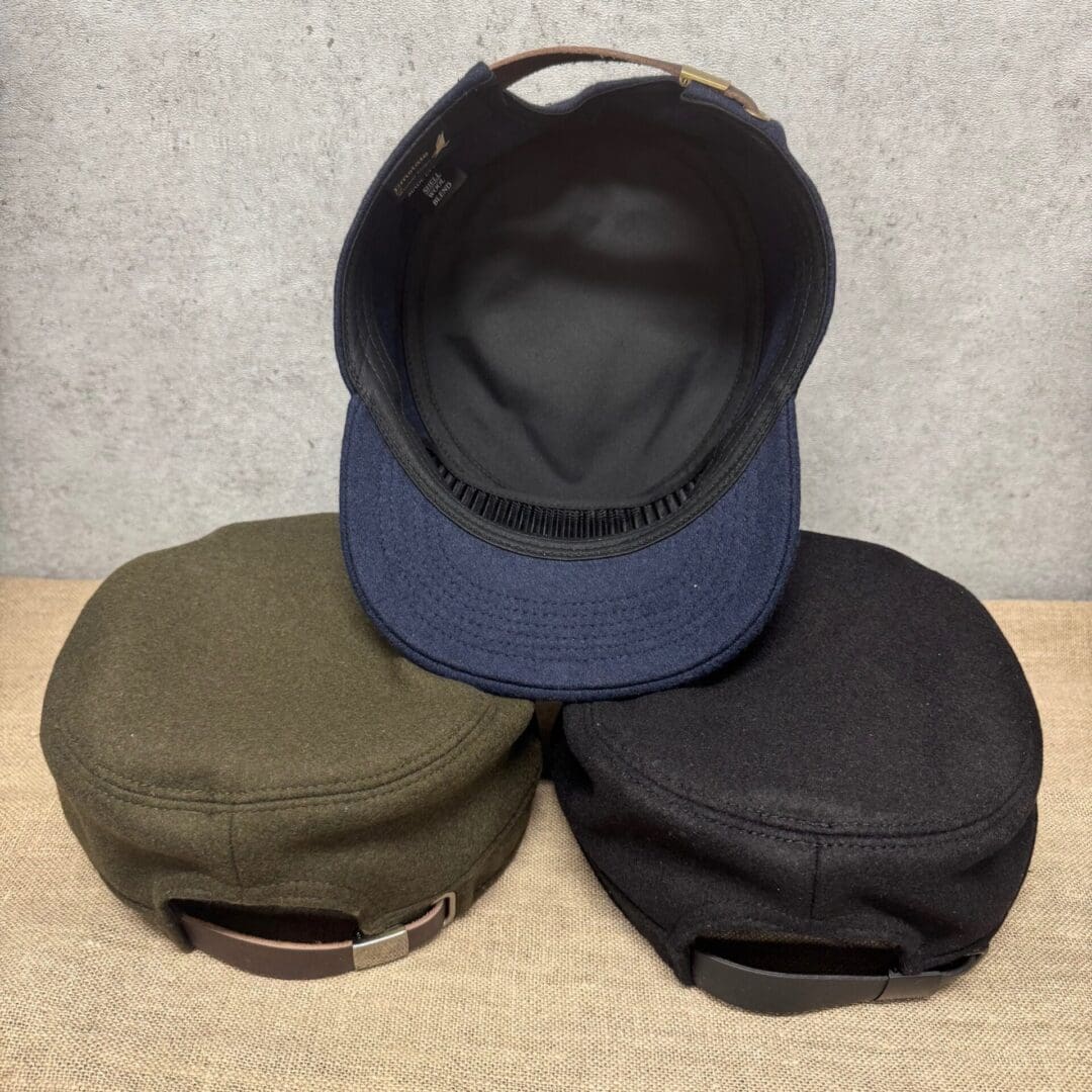 Three caps displayed on a textured surface.