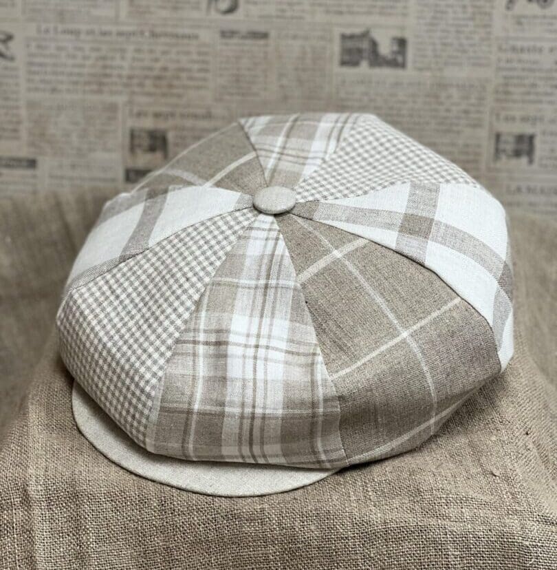 A hat is shown on top of the newspaper.