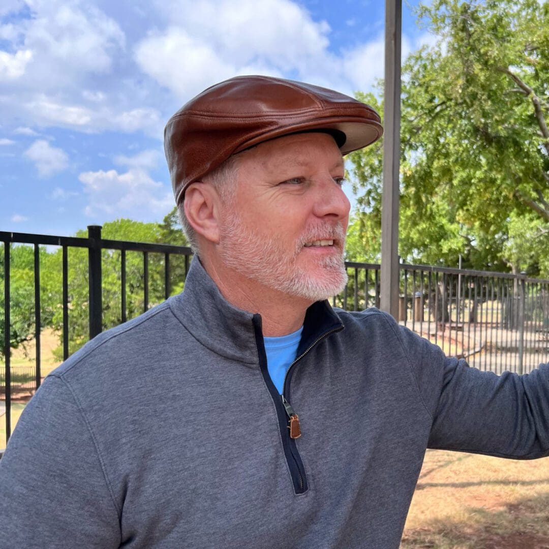 A man wearing a brown hat and gray jacket.