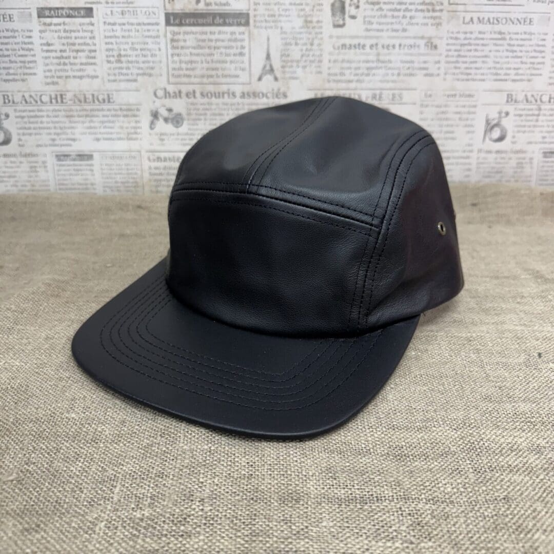 Black leather 5-panel camp cap.